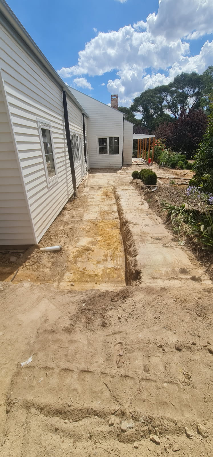 Residential trench cut beside a house ready for service works